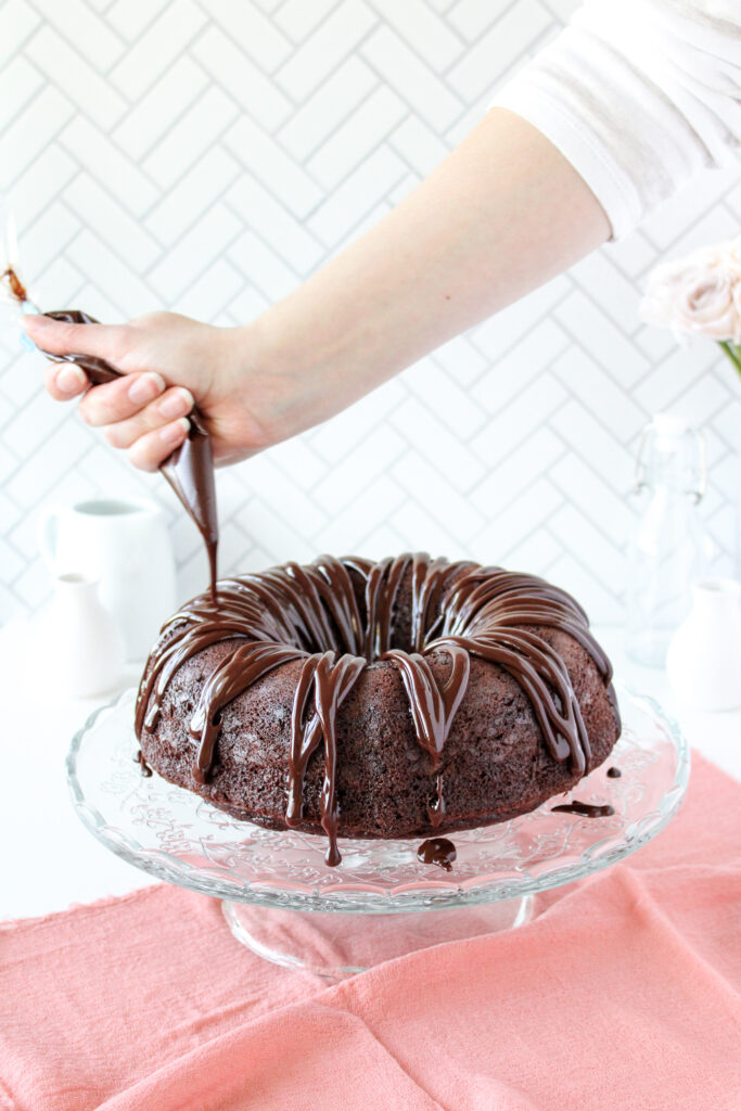 Drizzling chocolate ganache on the bundt cake