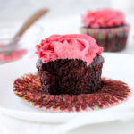 Bitten vegan chocolate cupcake on a plate