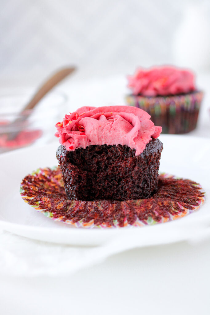 Bitten vegan chocolate cupcake on a plate