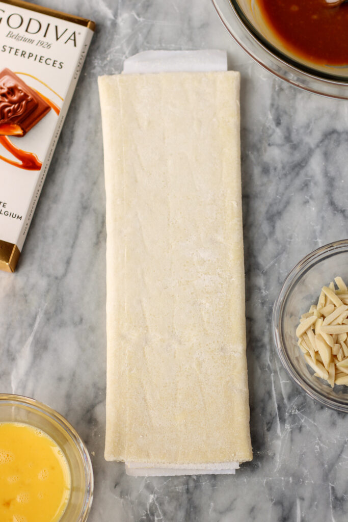 Puff pastry, chocolate, caramel, almonds, and an egg wash