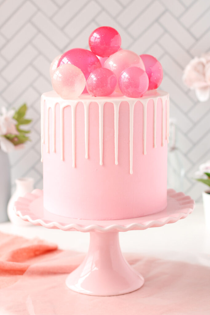 Pink champagne cake with gelatin bubbles on top