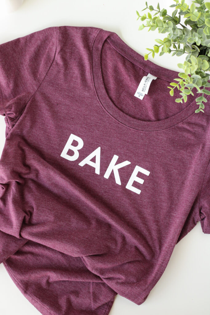 Maroon shirt with the word BAKE on the chest