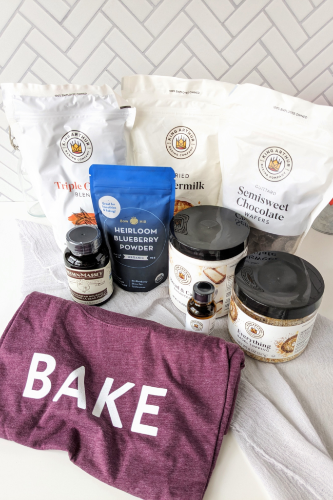 King Arthur Baking Haul: Bake shirt, blueberry powder, vanilla bean paste, chocolate wafers, cocoa powder, cake enhancer, dried buttermilk