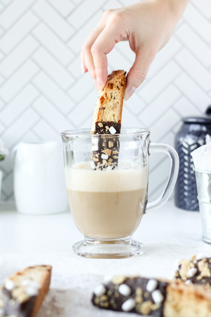 S'mores Biscotti being dipped into a tea latte