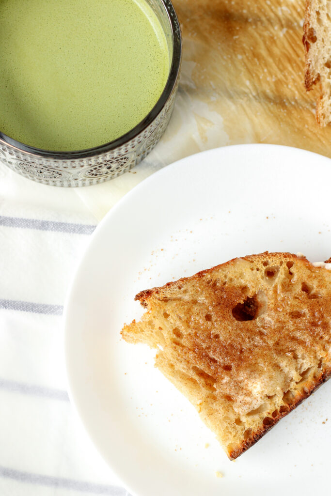 Toasted sourdough bread with butter and cinnamon sugar served with a matcha latte