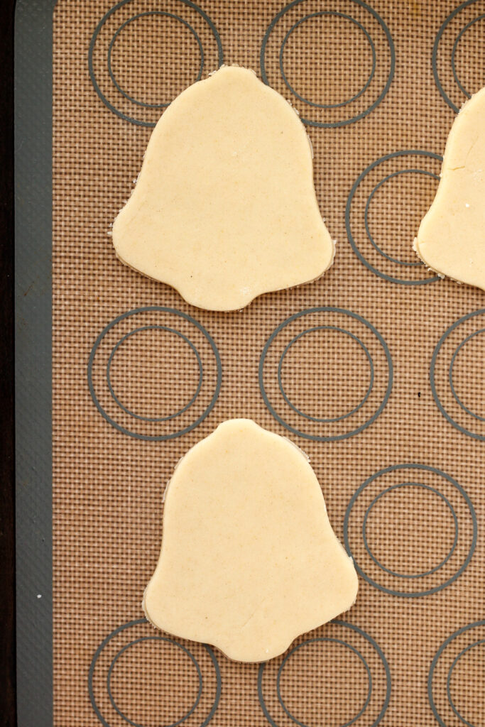 Cut out cookie dough on a baking sheet