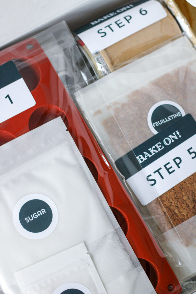 Opened box from Bake On full of ingredient packets