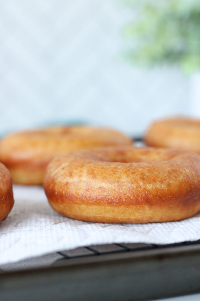Homemade Donuts on a paper towel lined cooling rack