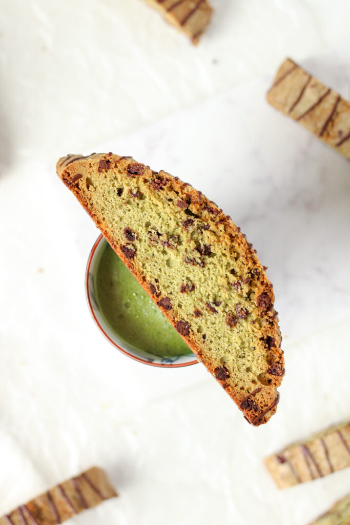 Matcha Chocolate Chip Biscotti on a mug with matcha latte
